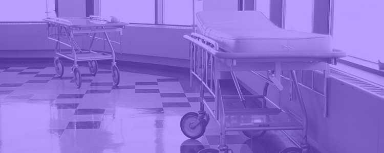 random hospital beds in a hospital hallway blocking traffic with a purple overlay