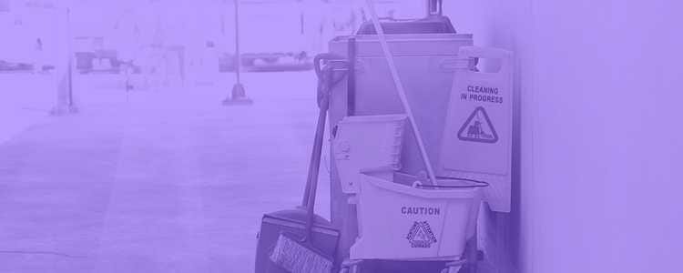 cleaning cart is in the middle of the hallway with a mop and several signs with purple overlay