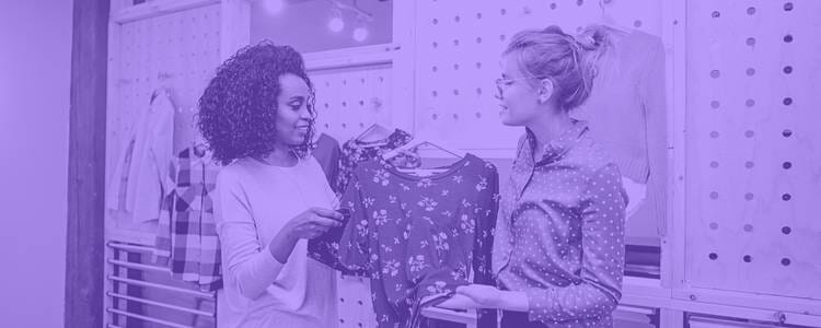 a sales clerk and customer engaging about a blouse in a purple overlay