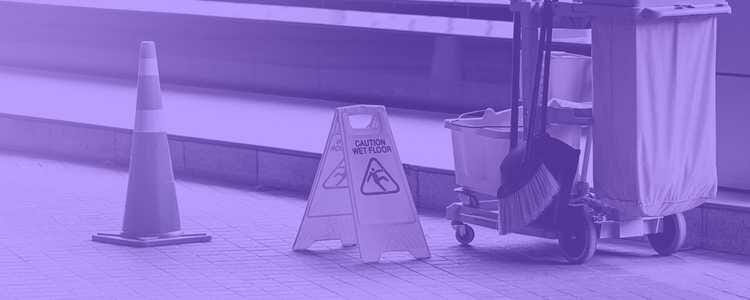 caution wet floor sign in front of a orange cone with a mop cart in purple overlay