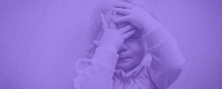 very upset child with their hands in front of their face crying in a purple overlay